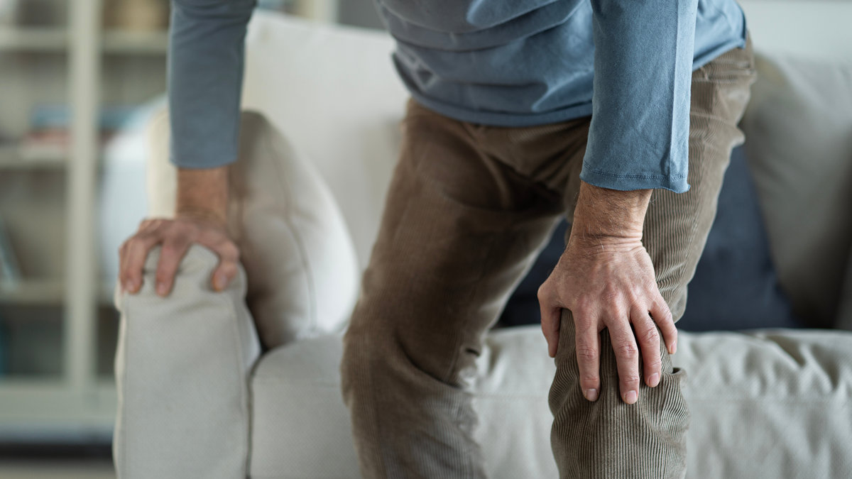 Old man suffering from knee pain