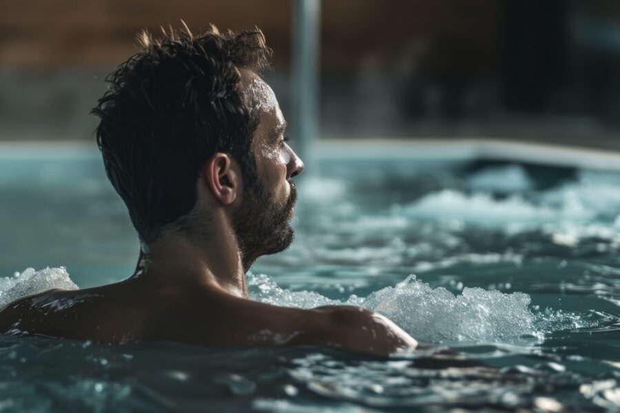 man sitting in a cold plunge tub