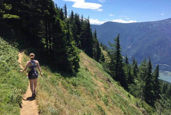 Summer Hikes in Oregon. Girl hiking in mountains or forest with summer cloths. Hobbies that are outdoors. Women enjoying a hike on her own. Hike with many trees and great view. Summer day adventures.