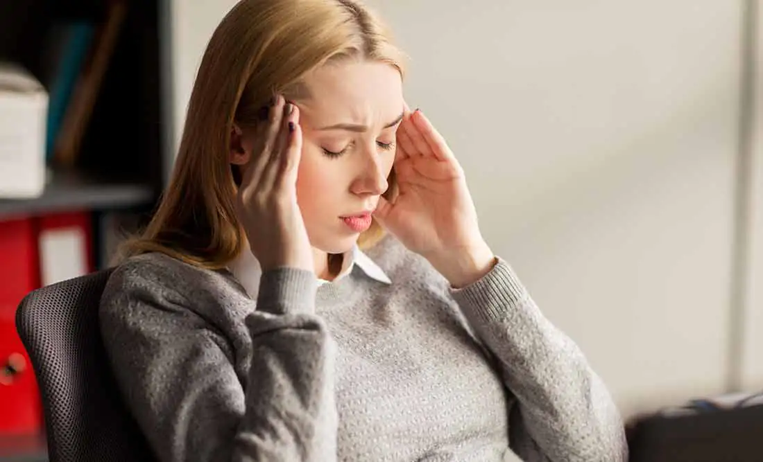The blonde girl has a headache.