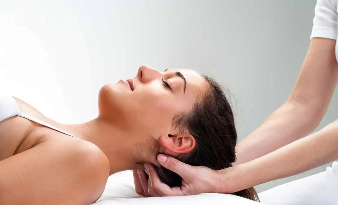 A girl receives a head massage