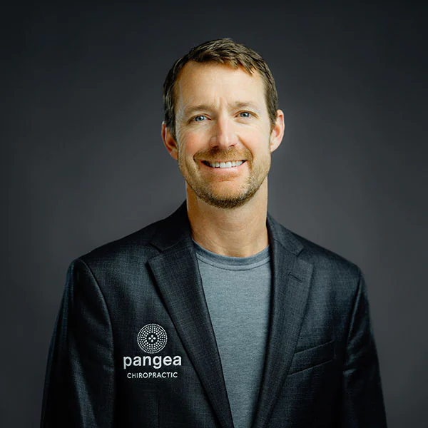 Dr. Tyge Shelby, Clinic Doctor at Pangea Chiropractic, wearing professional attire